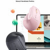 A pink vertical ergonomic mouse shown next to a laptop, highlighting its natural handshake position.
