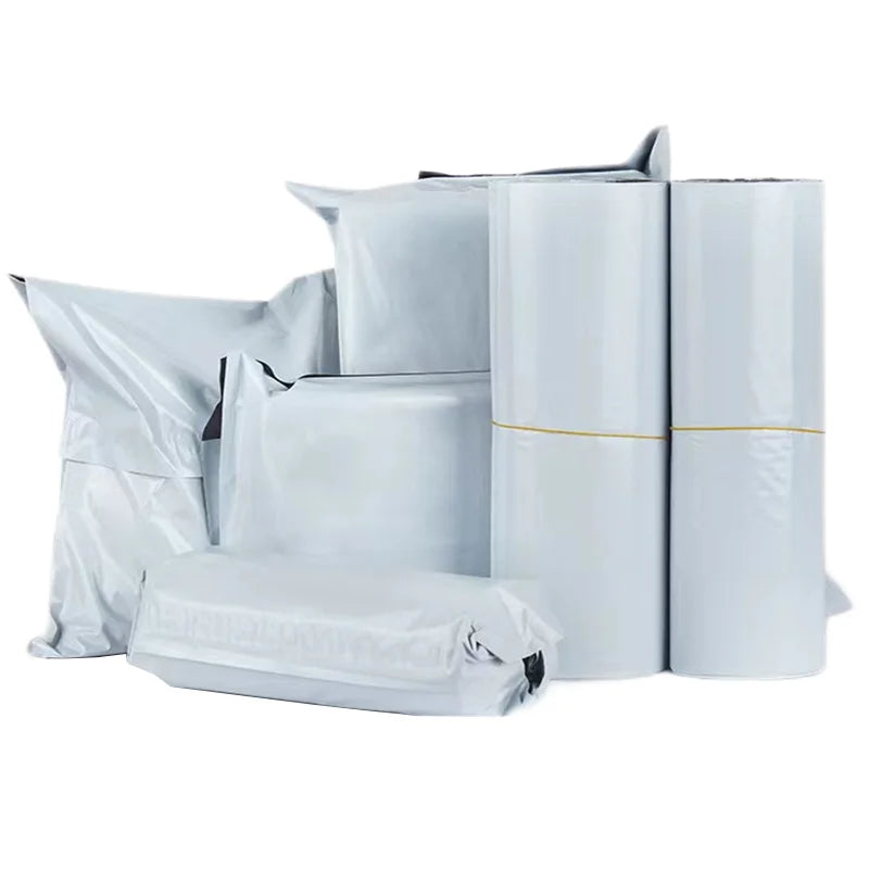 A collection of white, durable self-adhesive courier mailer bags in various sizes and formats.