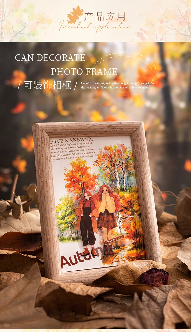 A wooden photo frame decorated with an autumn forest scene featuring two figures in vibrant fall foliage.