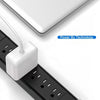 A white universal DC power adapter plugged into a black cable connector for a MacBook.