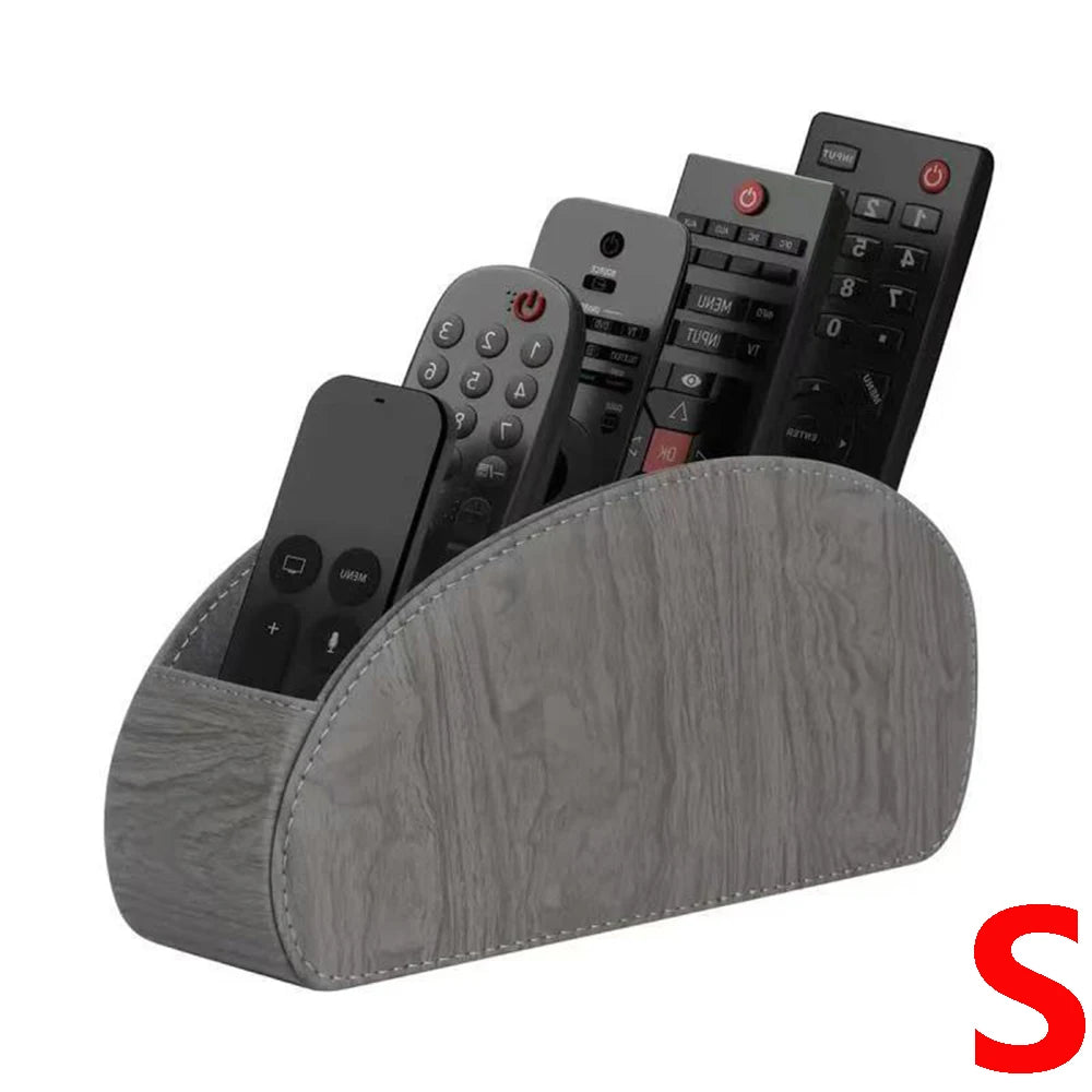 A grey PU leather remote control holder with five compartments displaying various electronic devices.