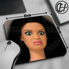 A close-up of a cute doll face mouse pad with a non-slip rubber base shown next to a laptop and a computer mouse.