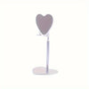 A silver adjustable desktop phone and tablet stand with a heart-shaped holder.