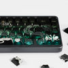 A close-up view of a black mechanical keyboard featuring dragon-themed side-lit PBT keycaps.