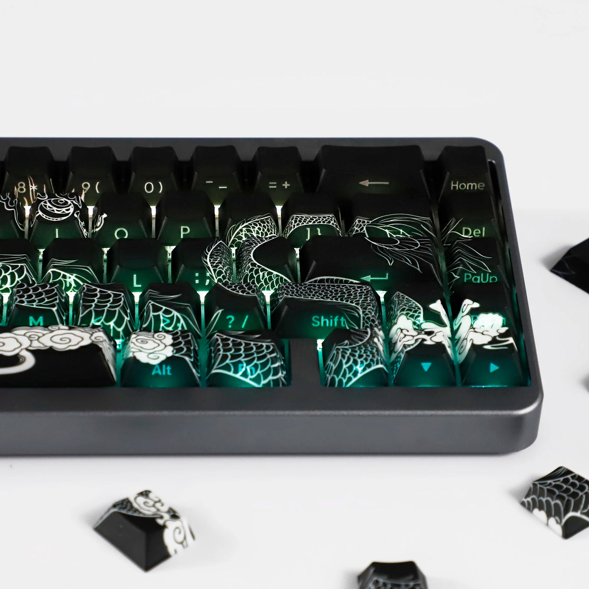 A close-up view of a black mechanical keyboard featuring dragon-themed side-lit PBT keycaps.