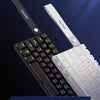 A close-up of a black and white mechanical keyboard with flowing visual symbols on the keycaps and a branded mouse shown next