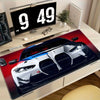 A large non-slip gaming mouse pad featuring a racing car design on a white and blue vehicle.