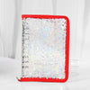 A red binder organizer with clear storage pockets filled with holographic star stickers.