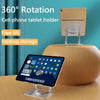 A beige cell phone tablet holder with a foldable design and a silver stand, shown on a wooden surface.