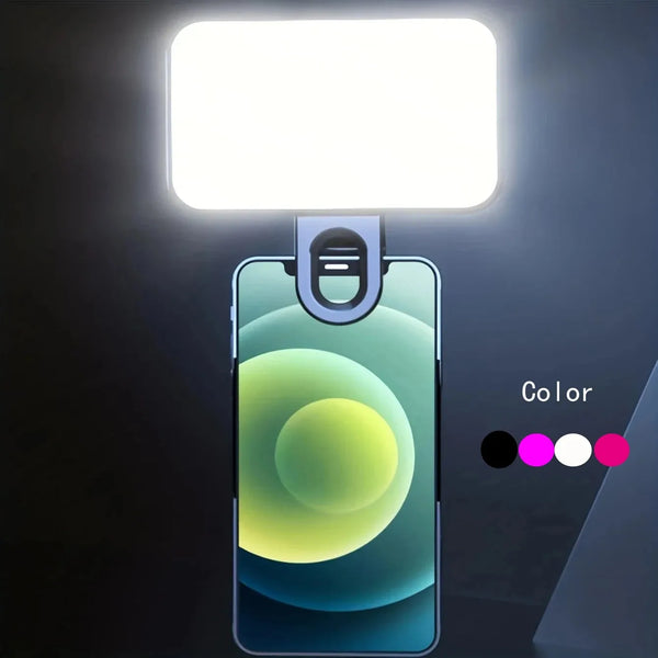 A portable rechargeable mini selfie light illuminates a smartphone displaying a gradient color effect.