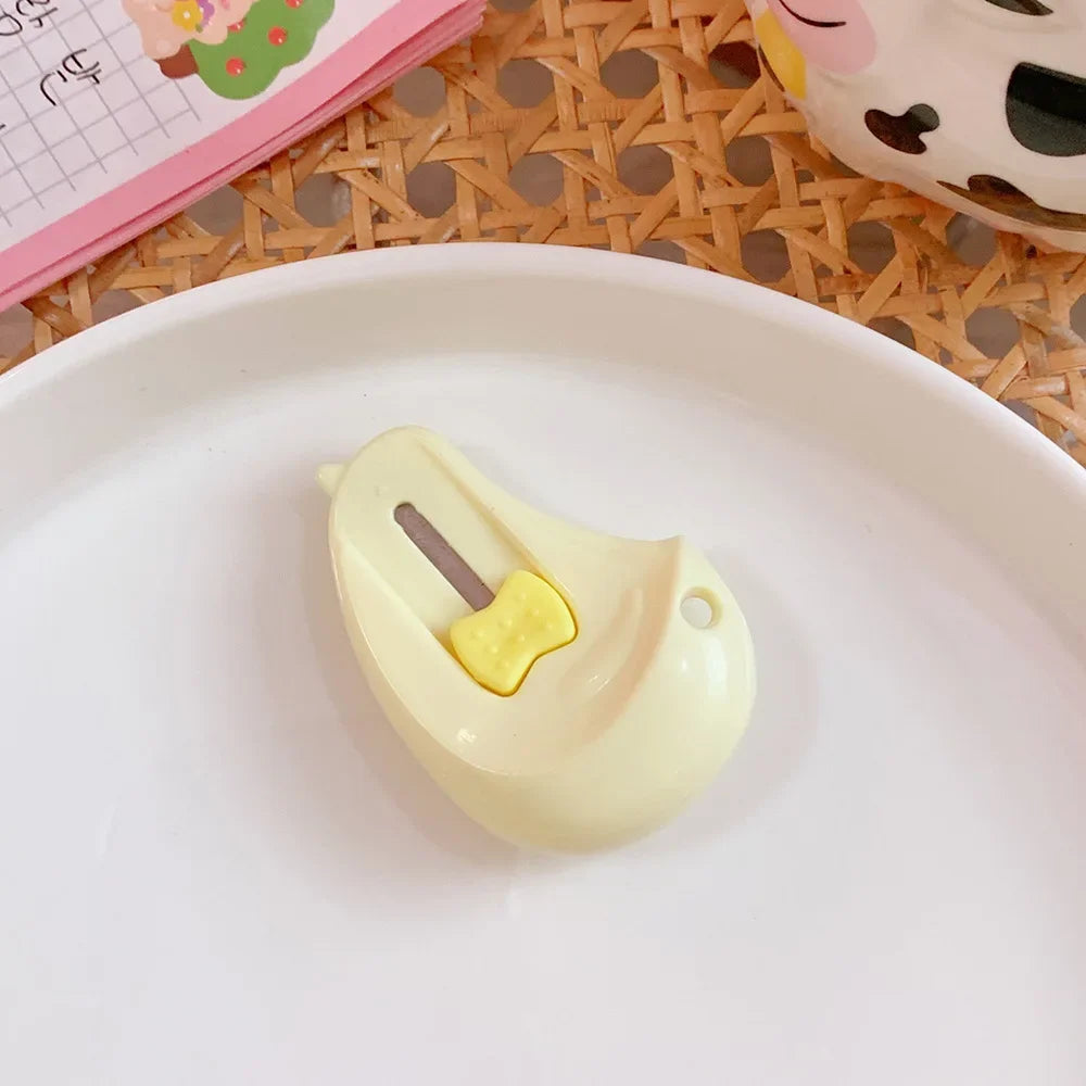 A small, light yellow cat paw-shaped mini cutter is placed on a white plate.