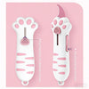 A white cat paw shaped mini box cutter with a pink handle and blade, shown against a pink background.