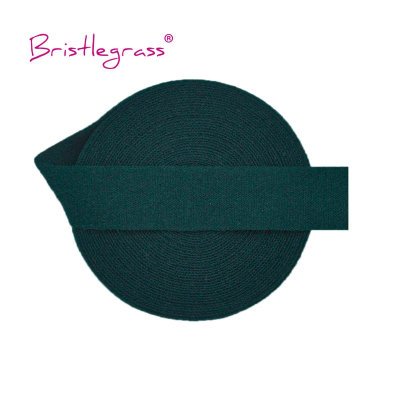 A dark teal or forest green elastic hair tie with a flat band design.