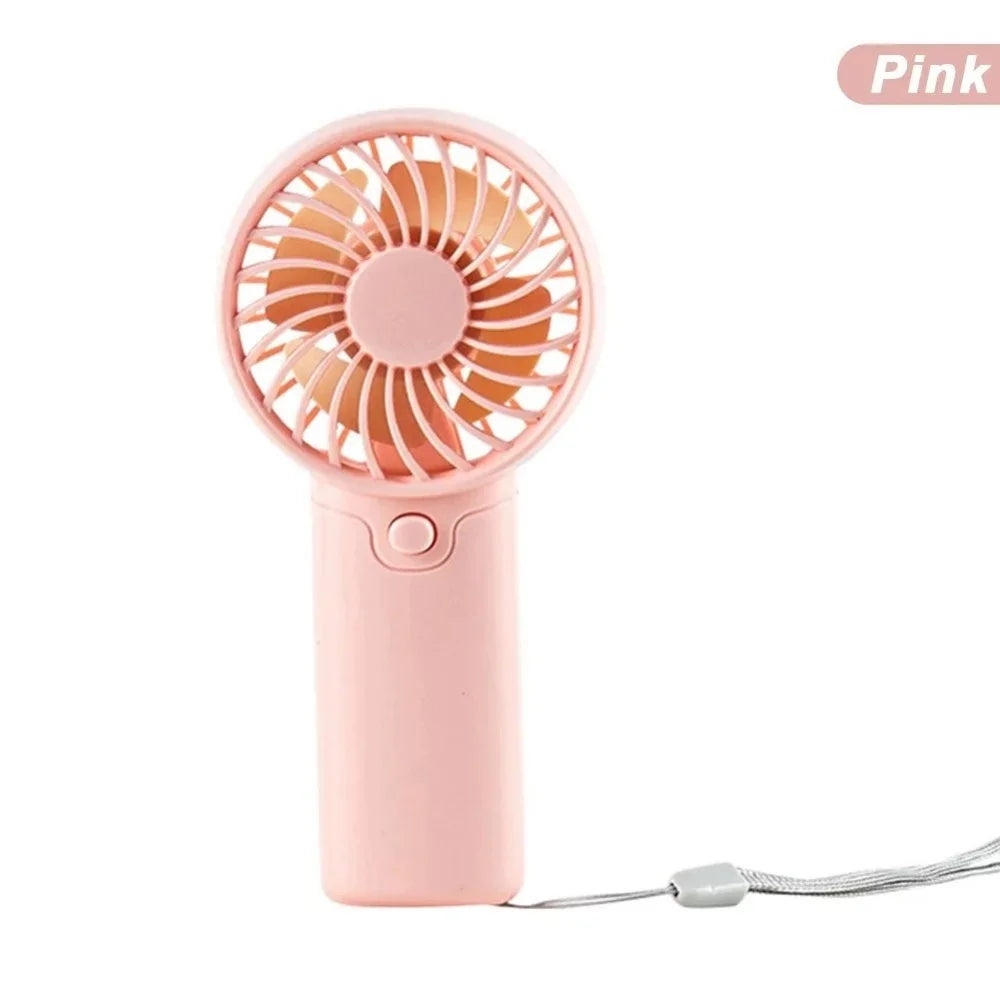 A pink portable rechargeable mini handheld fan with an orange blade and a cord.