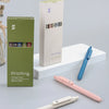 A set of piloting gel ink pens in various colors and a pink pen are displayed on a white surface.