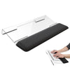 An ergonomic acrylic keyboard wrist rest stand with a black pad is shown next to a hand typing on a laptop.