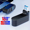 موزع USB متعدد المنافذ أسود من 4 في 1 مع محول أبيض على خلفية رمادية فاتحة.