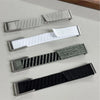 Three replacement watch bands for a Whoop 5.0 device in silver, white, and black nylon braiding.