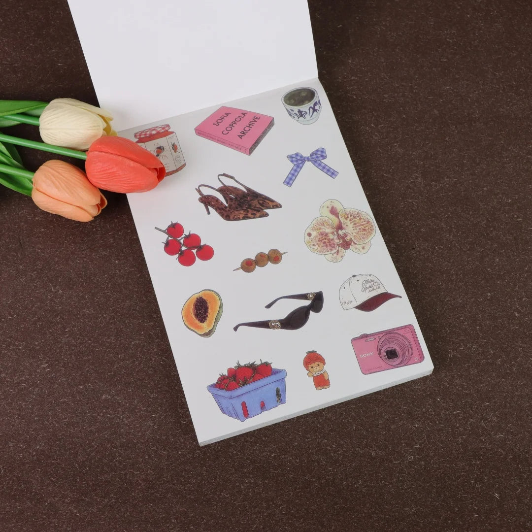 A page from a sticker book featuring various fruit icons like apples, oranges, and berries for crafting.