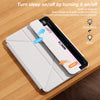A white magnetic protective case for an Apple iPad is shown resting on a wooden surface.