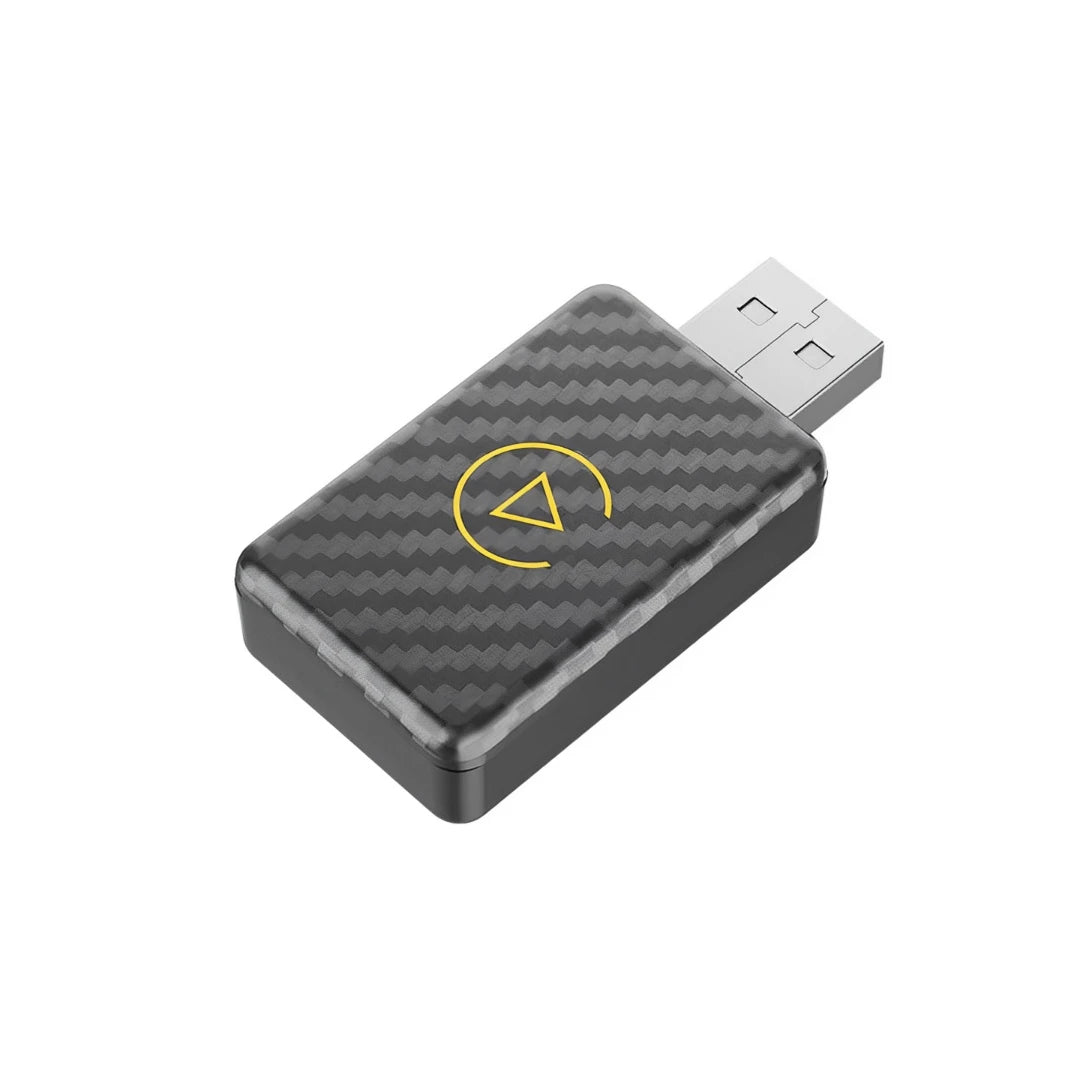 A black adapter for wireless CarPlay and Android Auto, featuring a yellow triangle icon on the surface.