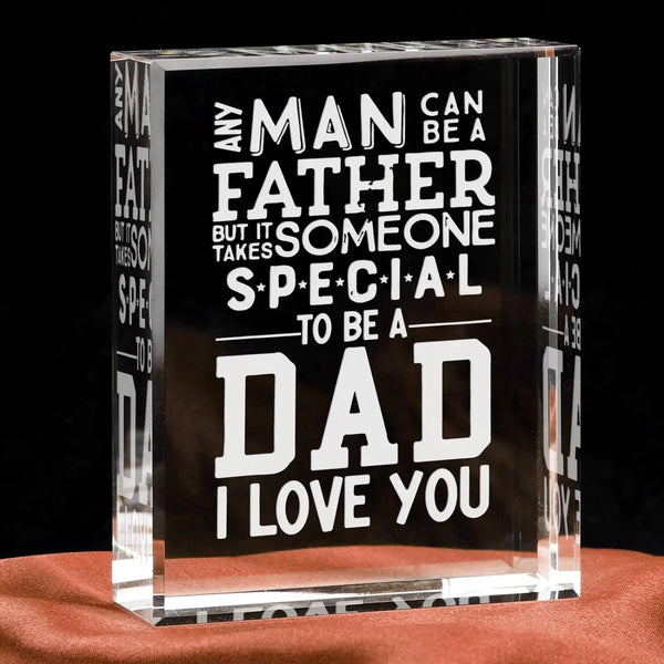 A clear glass block engraved with the text Any man can be a father but it someone special to be a dad I love you