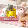 Pink cast kawaii ergonomic wrist rest featuring cute cat and pig figures on a pink box.