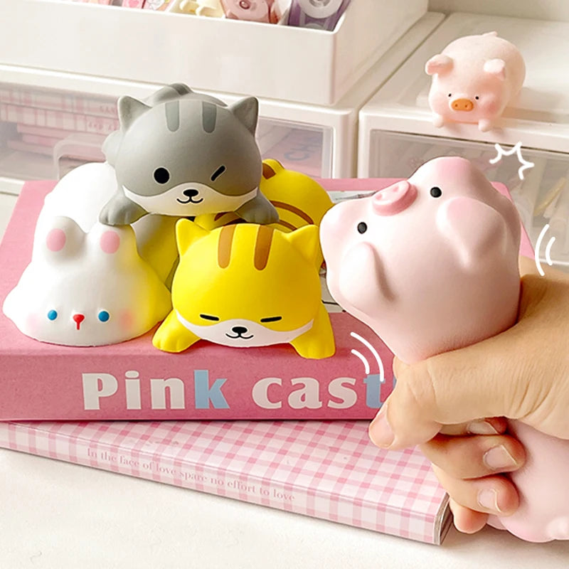 Pink cast kawaii ergonomic wrist rest featuring cute cat and pig figures on a pink box.