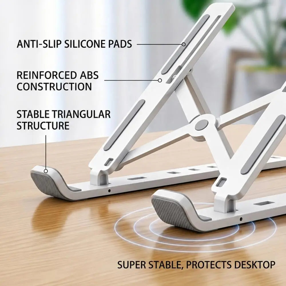 A white adjustable foldable laptop cooling stand featuring anti-slip silicone pads and a stable triangular structure on a woo
