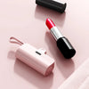 A pink portable DIY power bank shell next to a black cosmetic tube and a black cylindrical object.