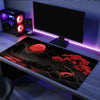 A large silicone gaming mouse pad is displayed on a desk with RGB lighting and a computer monitor.