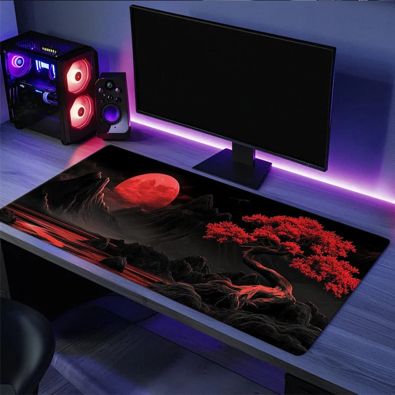 A large silicone gaming mouse pad is displayed on a desk with RGB lighting and a computer monitor.