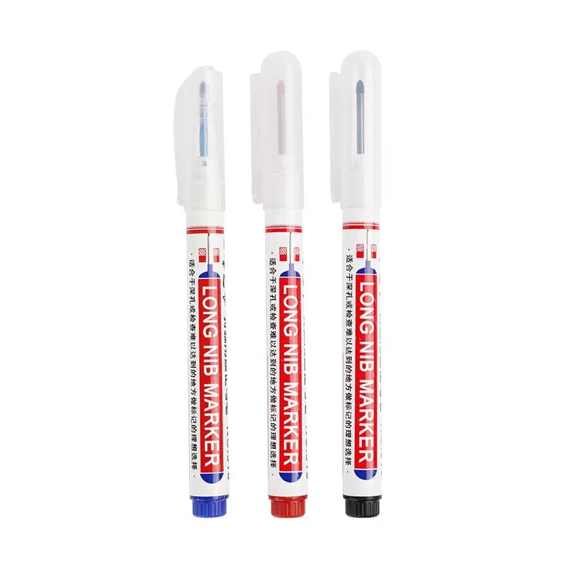 Three white permanent paint marker pens with clear tips and black barrels are shown side by side.