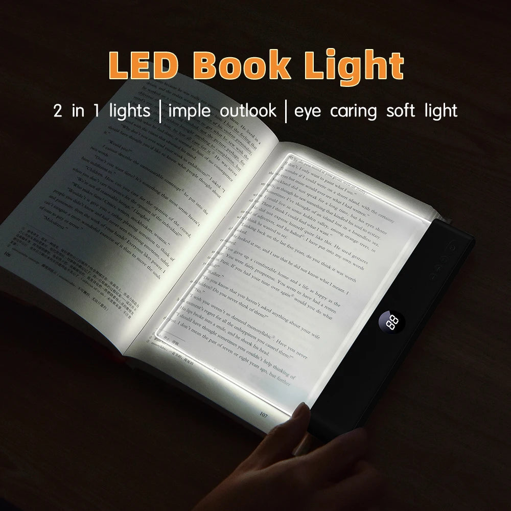 A hand holds an open book illuminated by a black LED book light with a timer feature.