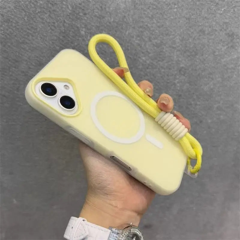 A hand holds a yellow phone case with a white circular design and a yellow lanyard against a gray background.