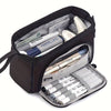 A black canvas double-deck pencil case filled with various writing instruments and supplies.