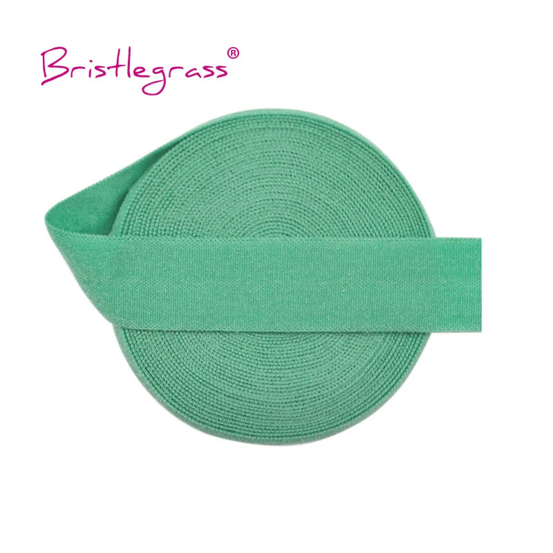 A green bristleglass elastic hair tie with a matching green band.