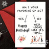 A red envelope with a humorous birthday card inside that asks, Am I your favorite child?