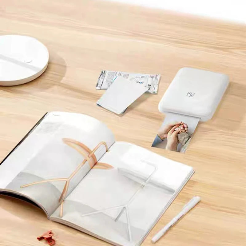 A white sheet of high-adhesive photo sublimation paper is shown next to an open photo album.