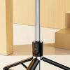 A black compound tripod stand with a long pole and crossbar is shown on a light surface.