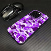 A purple and green leopard print anti-fall phone case is shown next to a black wireless mouse on a dark surface.