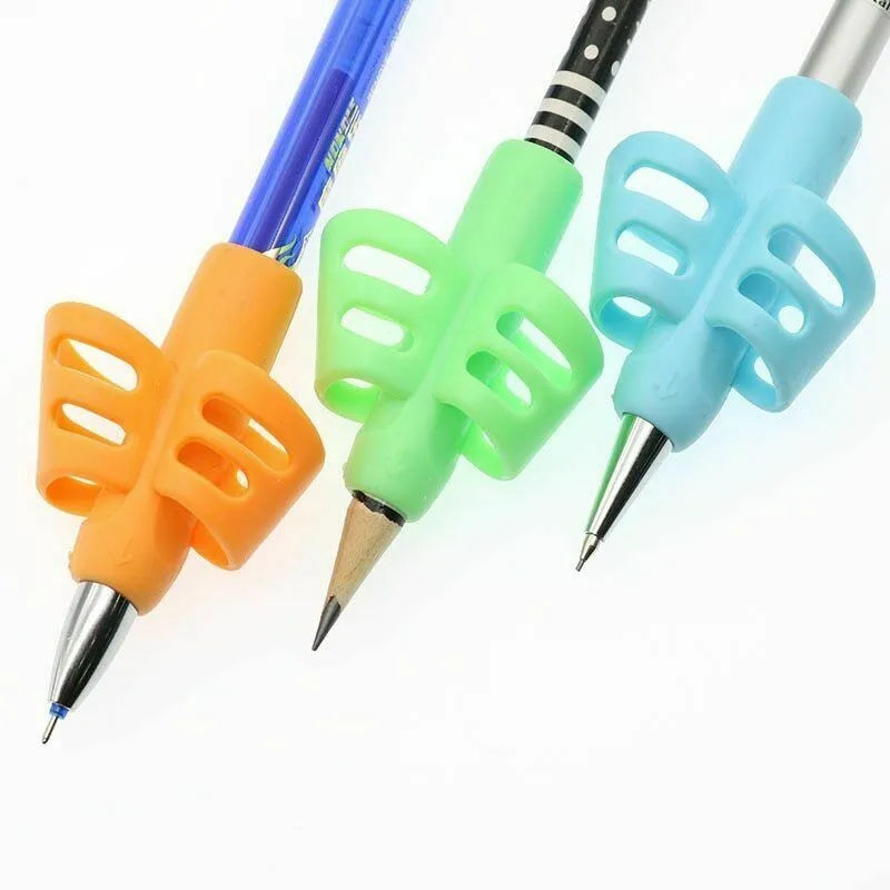 A set of silicone pencil grips in orange, lime green, and light blue colors for children's writing.
