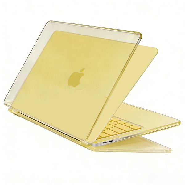 A clear protective case is shown open, displaying a yellow-tinted laptop with a silver keyboard.