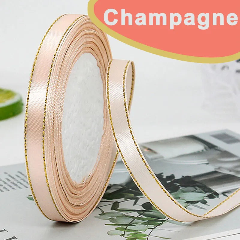 Roll of pink satin ribbon with gold edge for wrapping or crafting