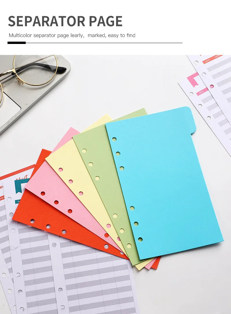 A stack of colorful A6 budget planner pages and a blue binder with envelope pockets for separation.