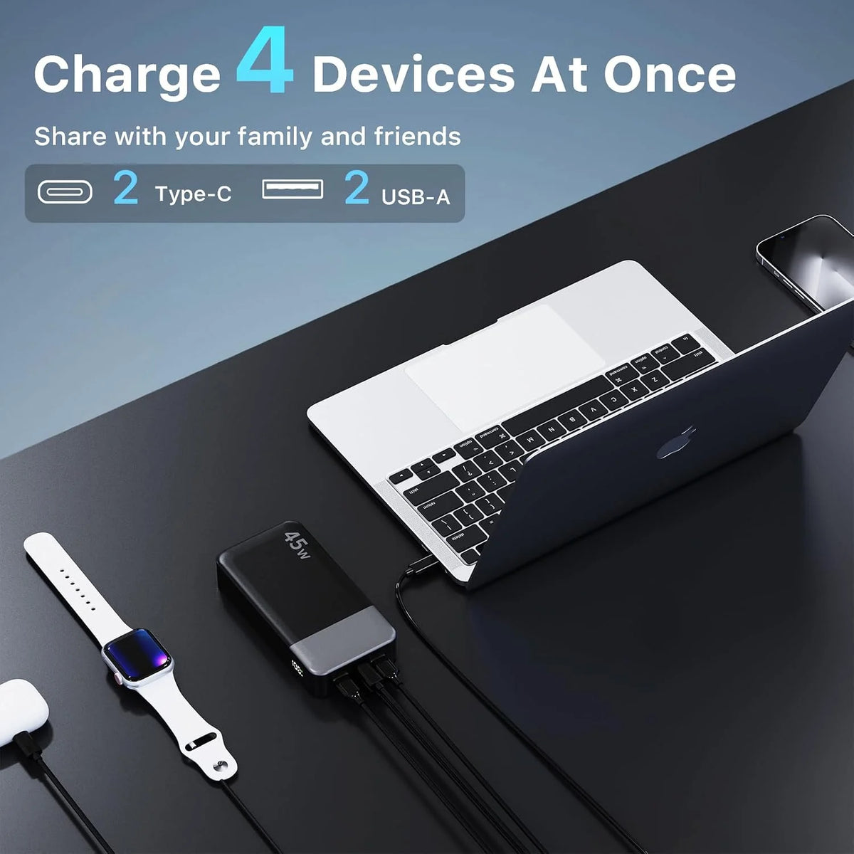 A portable power bank is shown charging four devices simultaneously, including a laptop and a smartwatch.