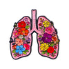 An enamel pin shaped like a human lung, decorated with colorful flowers and leaves.