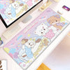 A colorful cartoon gaming desk mat featuring cute white cats and pink elements, placed next to a laptop.
