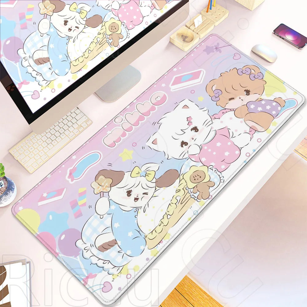 A colorful cartoon gaming desk mat featuring cute white cats and pink elements, placed next to a laptop.
