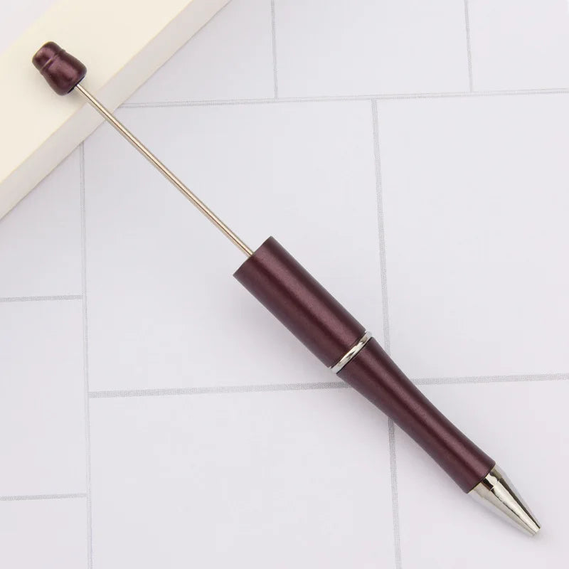 A set of DIY beadable pens with black ink, featuring dark maroon and silver accents.